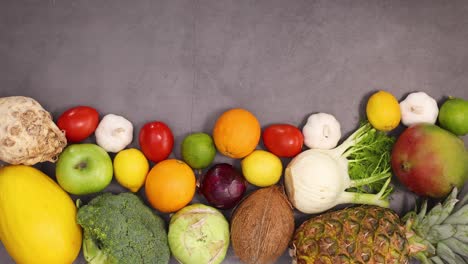 organic healthy fruits and vegetables ordering on the bottom of kitchen table. stop motion