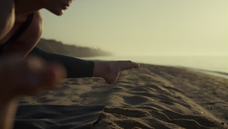 sportswoman making gymnastics exercises on beach. yoga woman standing crane pose