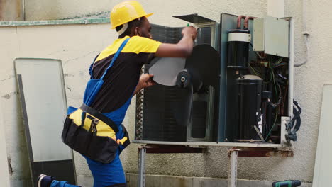 expert removing dust from blower fan