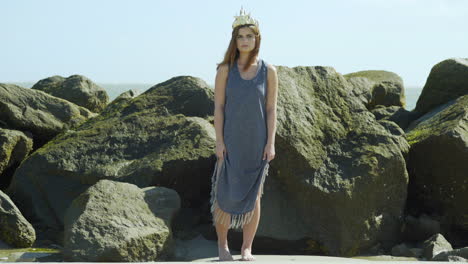 Aquatic Model on Beach Gives Smoldering Look Against Rocks, Wide