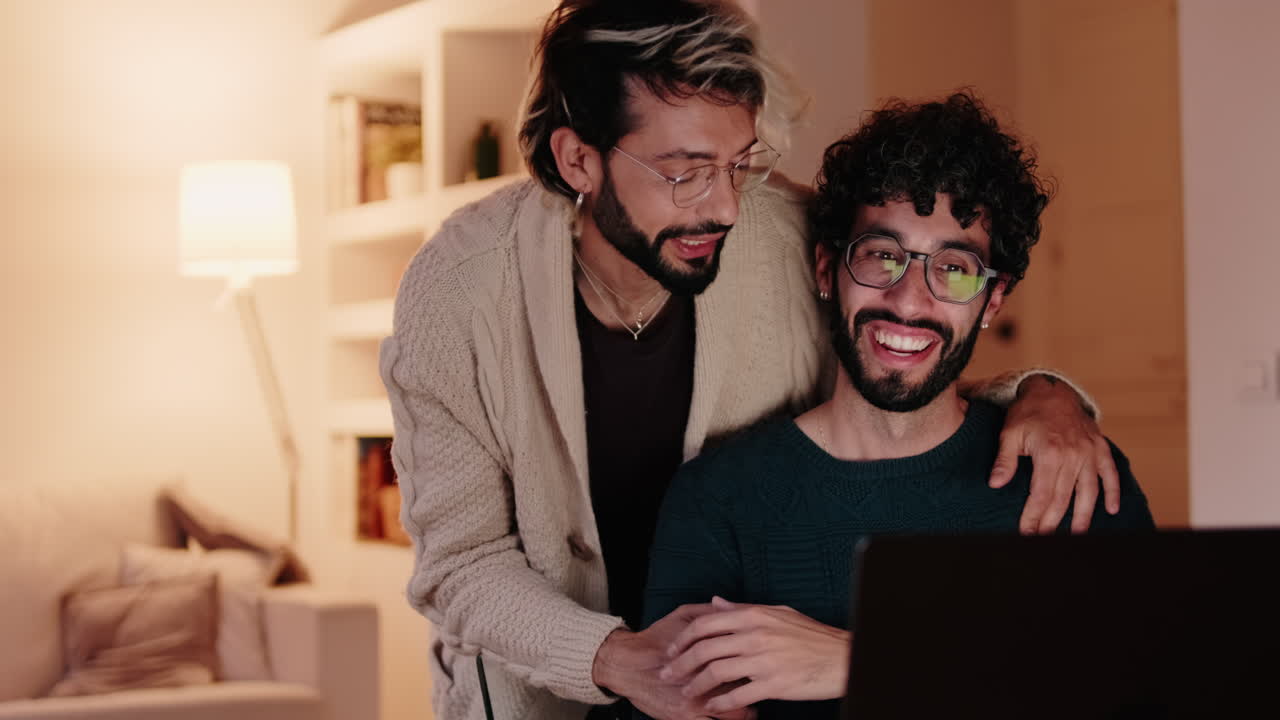 Gay Couple Working From Home on Laptop