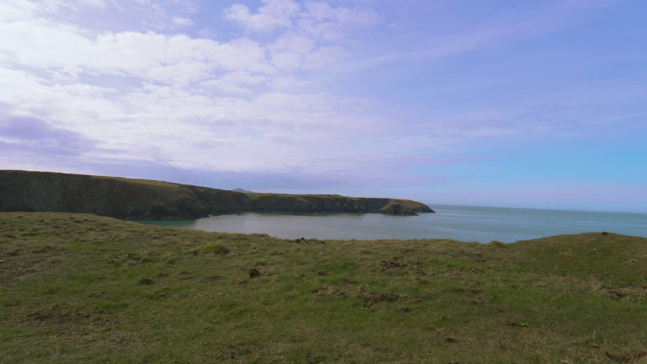 Timelapse of Welsh Coastline in Pembrokeshire with Clouds in Sky Passing By with Various Beaches and Coves in Distance.