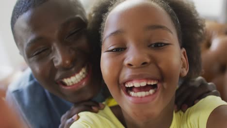 video of african american father and daughter talking and playing