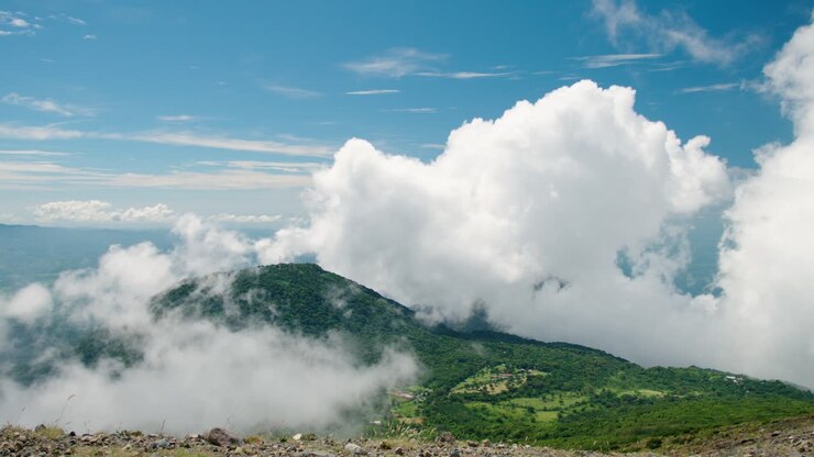 The Cerro Verde mountain in Santa Ana, El Salvador during a cloudy day with low altitude clouds covering the summit - handheld camera movement to the right