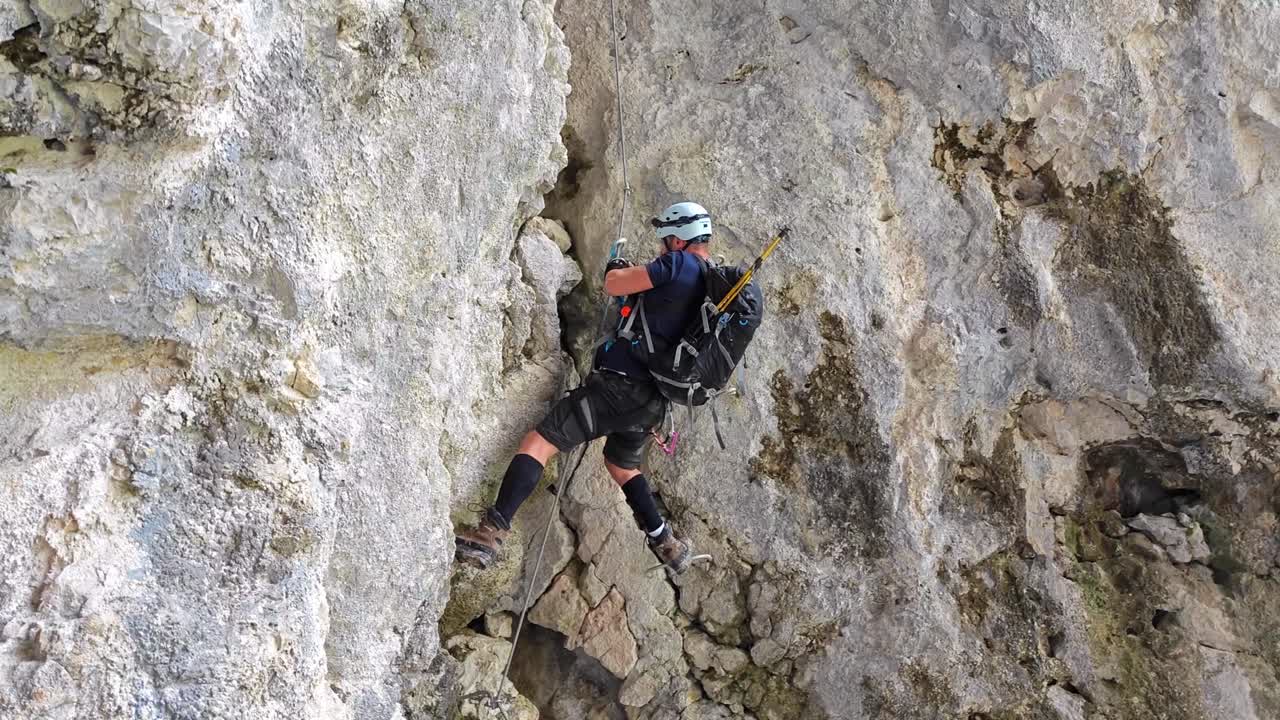 A Mountaineer Ascends a Rocky Peak in Alta Badia, Dolomites, Italy - Slow Motion