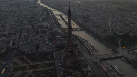 Elevated-footage-of-Eiffel-Tower-near-Seine-river.-Panoramic-view-of-metropolis-at-dusk.-Paris,-France