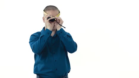 guy-in-dark-blue-shirt-holds-yellow-measuring-tape