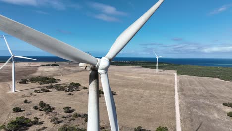 orbiting drone shot of spinning wind turbine