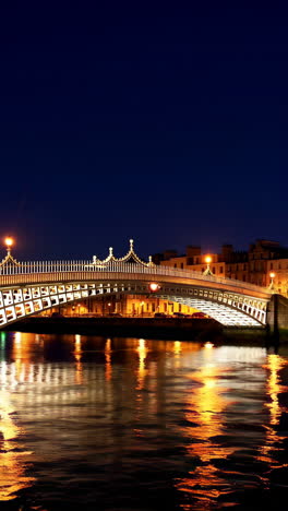 the ha'penny bridge in dublin, ireland at night