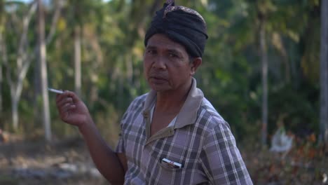 Close-up-shot-of-a-traditional-balinese-male-spiting-and-smoking