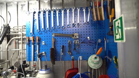 small organized toolboard inside corner of ships engine room - handheld