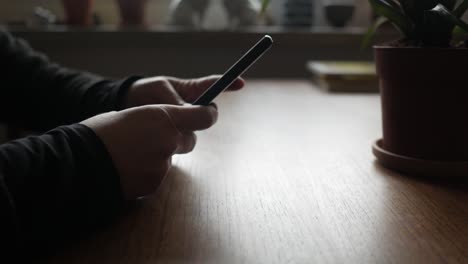 Bored-female-hands-take-smartphone-and-put-in-down-on-the-table