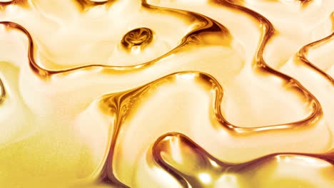 looped abstract background with wavy sparkling golden liquid pattern on shiny glossy surface. viscous blue fluid like surface of gold foil or brilliant glass. beautiful creative festive backdrop.