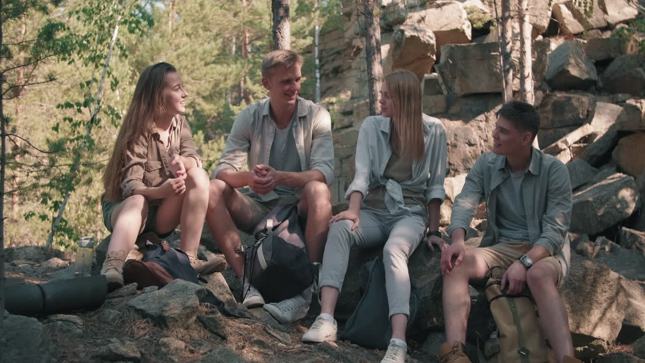 Young Friends Relaxing and Chatting on Hike