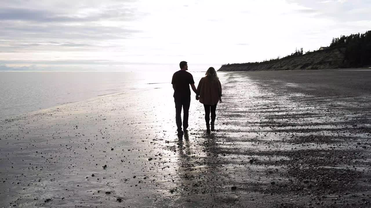 Couple walking on beach in Kenai, Alaska
