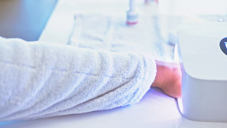 hands on woman at salon, nail polish