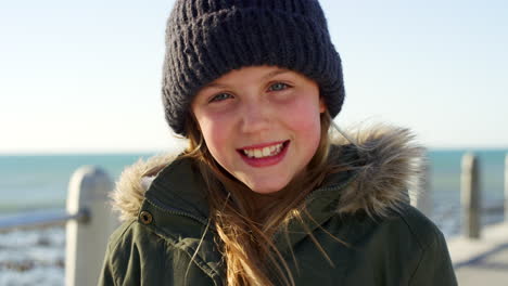 ocean, happy and face of child on winter vacation