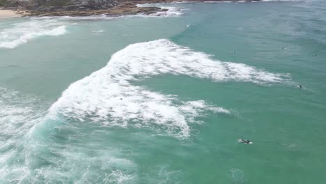 surfing at tamarama beach - surfer fell off the surfboard due to stong waves in sydney, nsw, australia