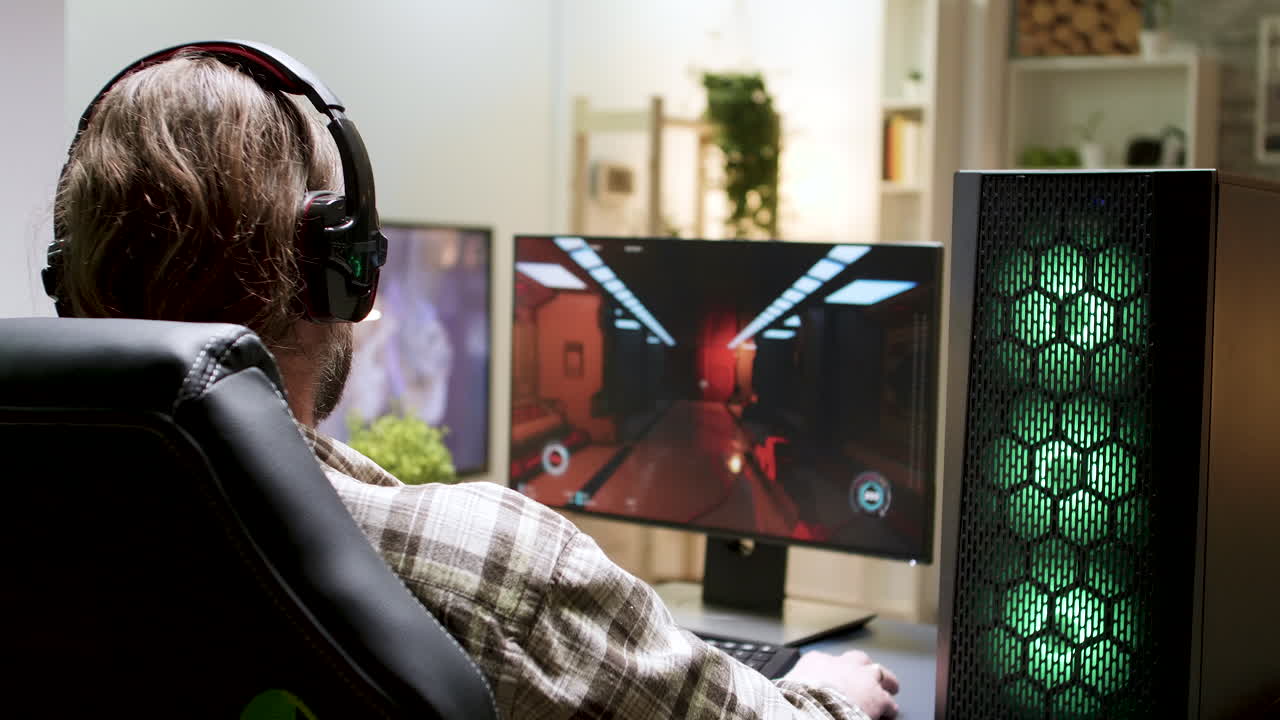 Gamer playing video game with headphones on PC