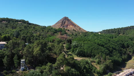 old mining site spoil tip in a forest alès france aerial shot sunny day blue sky