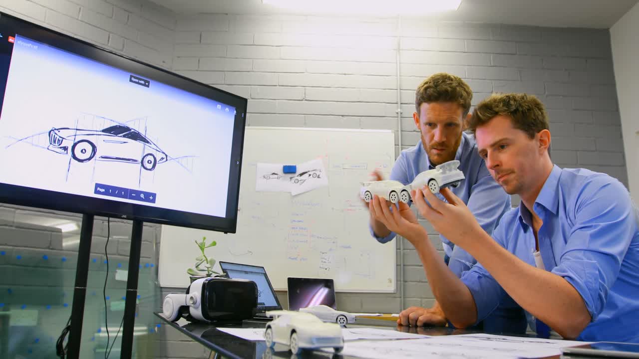 Business colleagues discussing over car model 4k
