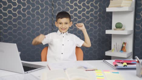 boy at home looking at camera and rejoicing.