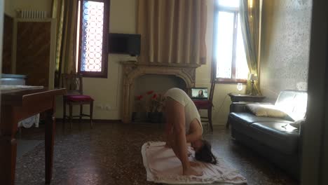Woman practicing yoga at home in Venice