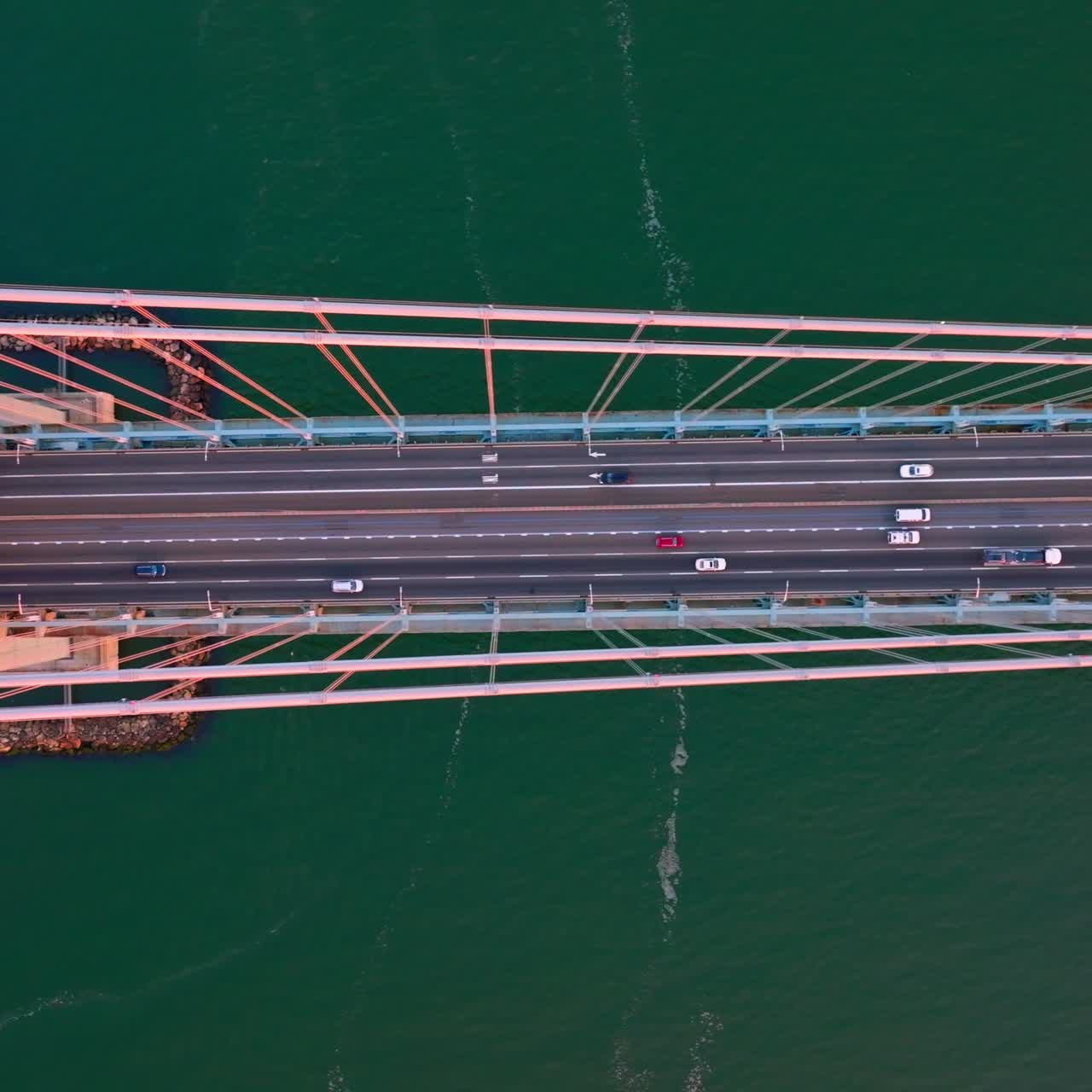 Speed motorways on the Whitestone bridge in New York. Flying high over the bridge construction at the backdrop of turquoise water of river