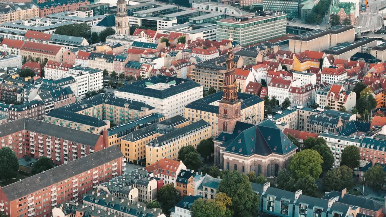Aerial establishing view of Copenhagen at sunrise featuring the Church of Our Savior