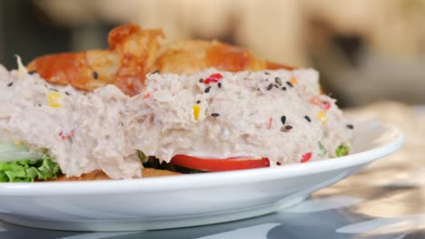 Tuna-sandwich-with-mayonnaise-on-a-plate-on-table