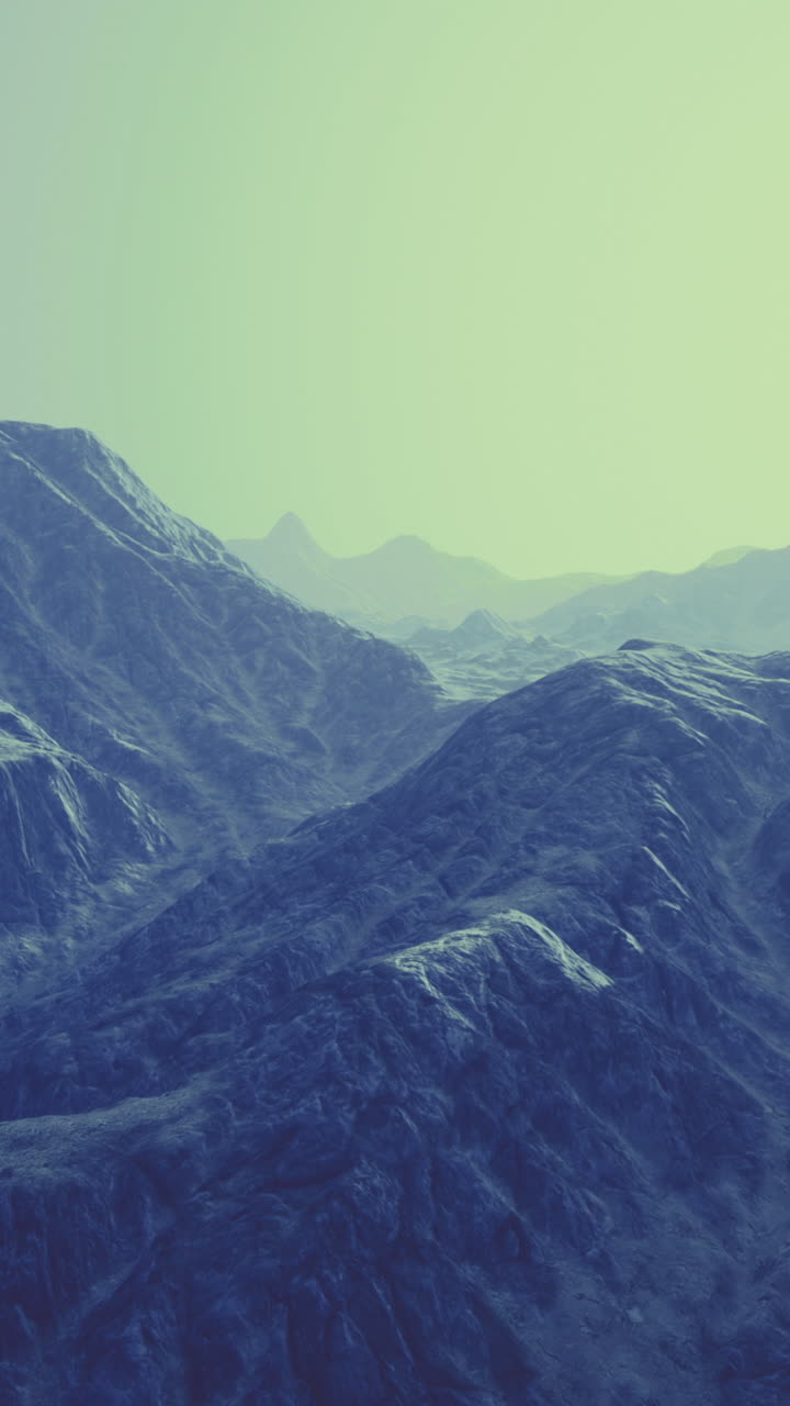 Mountains bathed in soft light revealing textured peaks and valleys