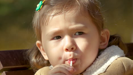 extreme close up, korean-ukrainian girl sucking on lollipop, yangjae park, south korea