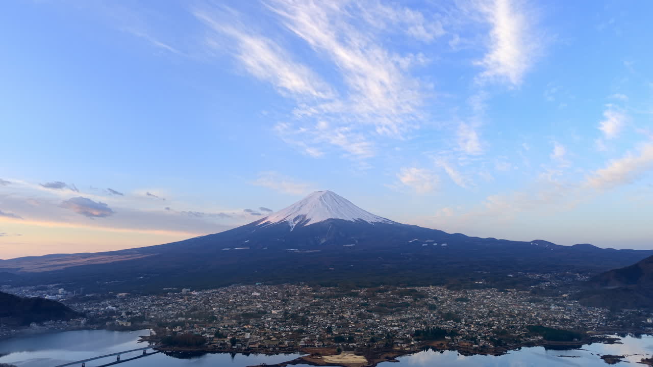 Aerial drone view of Lake Kawaguchiko near the Fujikawaguchiko town, Japan with Mount Fuji on the background in the evening