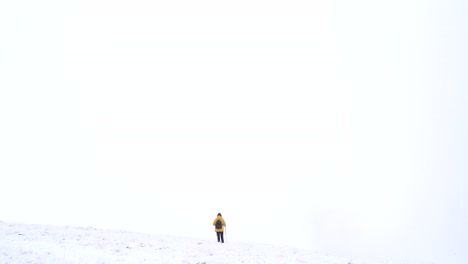 Unrecognizable-traveler-in-mountains-in-winter