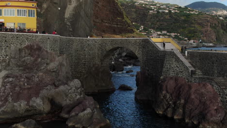 aerial shot in approach to the bridge of the city ponta do sol on the island of madeira on a sunny day