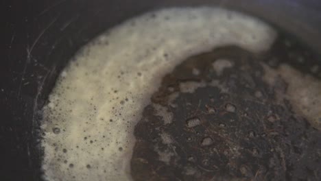 slow motion shot of onions thrown in to a hot pan with melted butter