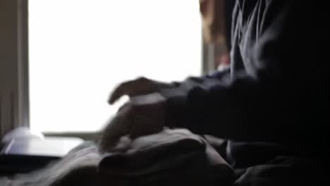 A Focused Moment: Folding Textiles with Care and Precision in Soft Hue Lighting