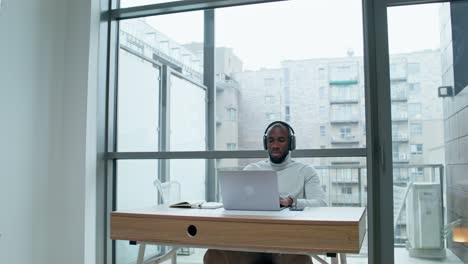 man working on laptop in modern office