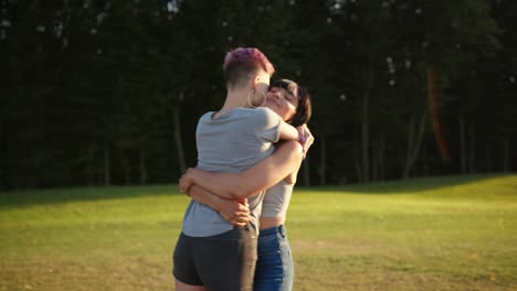 happy brunette lesbian woman circles her girlfriend in her arms, close up