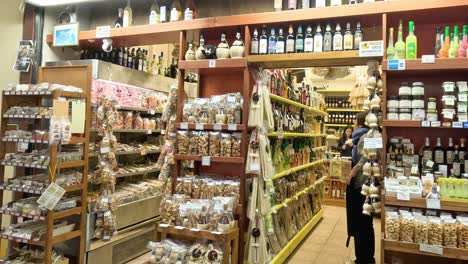 person shopping in a well-stocked grocery aisle