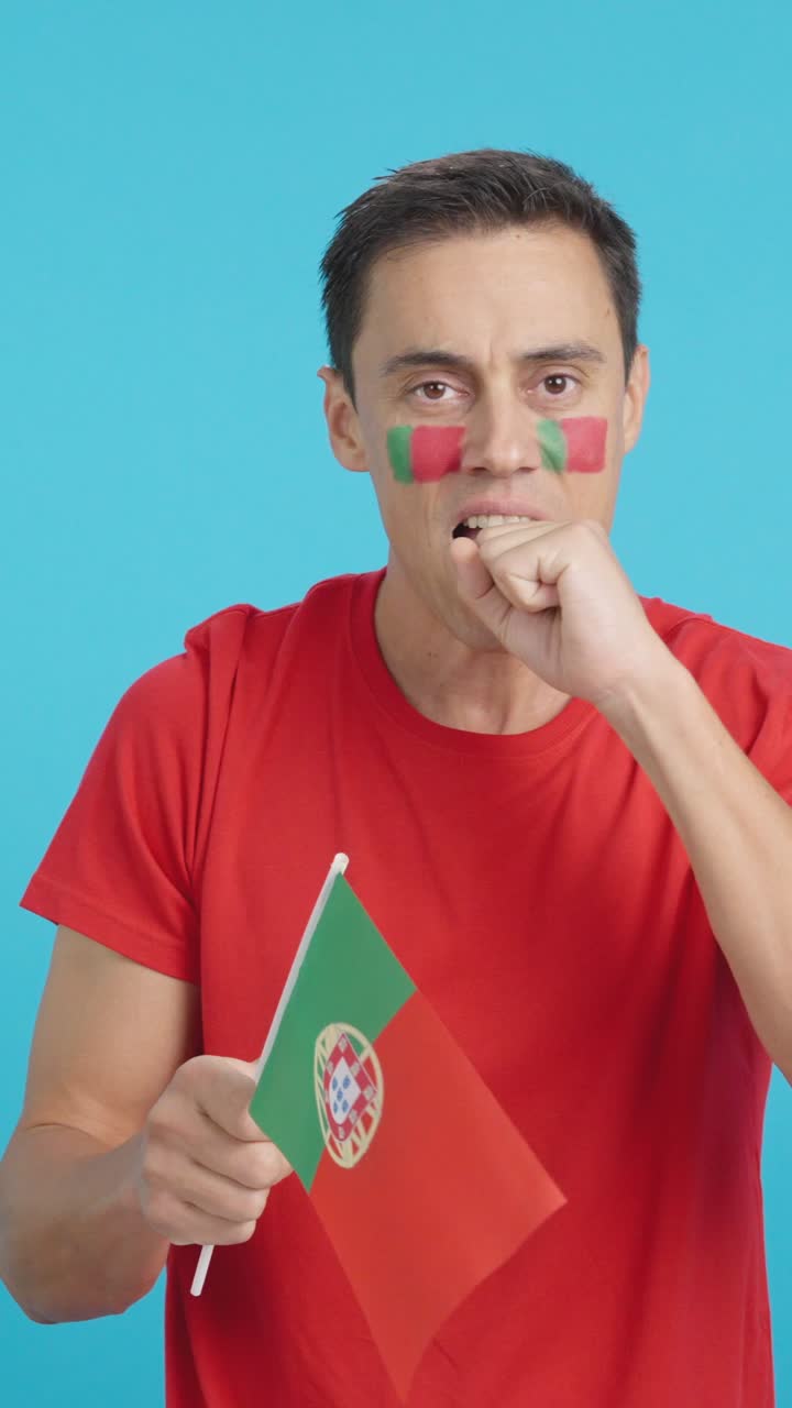 Man cheering for Portugal during a match that is lost