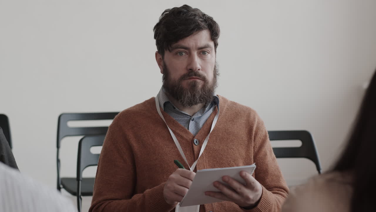 Man Taking Notes on Conference