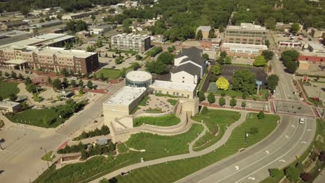 flint hills discovery center in downtown manhattan and blue sky on horizon, kansas, circle aerial tilt up