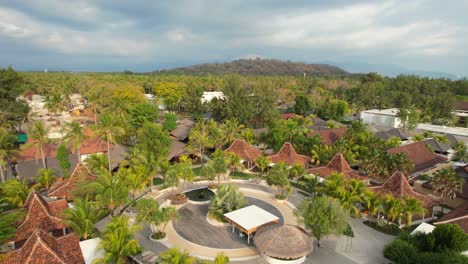 FRii-Resort-in-Gili-Trawangan,-Lombok,-Indonesia---Aerial-Fly-Over-Orange-Roofed-Small-Private-Rental-Villas-in-Lush-Tropics-on-Sunny-Day