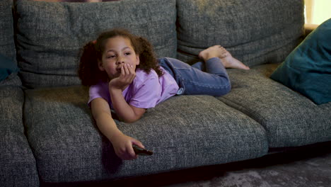 kid watching film at home