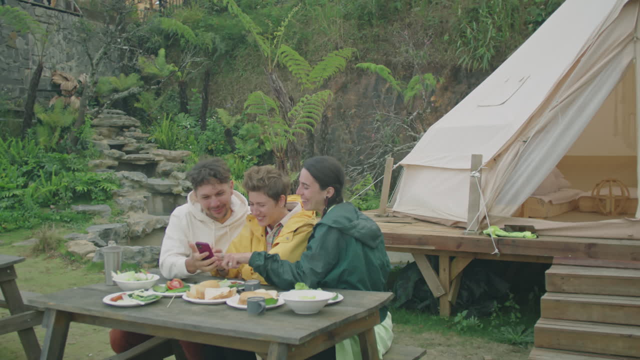 Positive Friends Taking Selfie during Meal at Glampsite