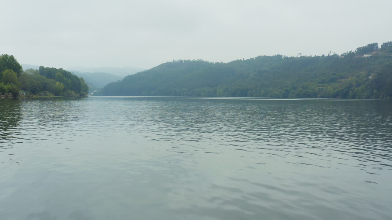 Scenic lake view with hills and trees