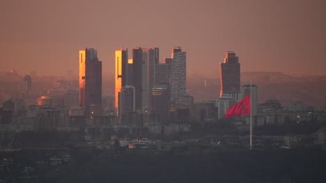 Istanbul-financial-district-and-a-turkish-flag-during-sunset-,