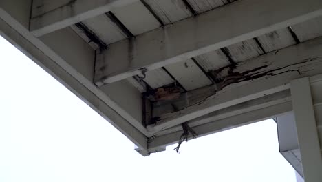 damaged support beams on a wooden deck in need of repair