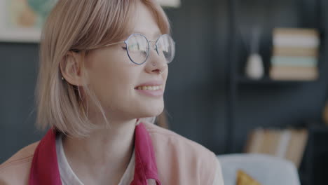 young woman smiling with glasses